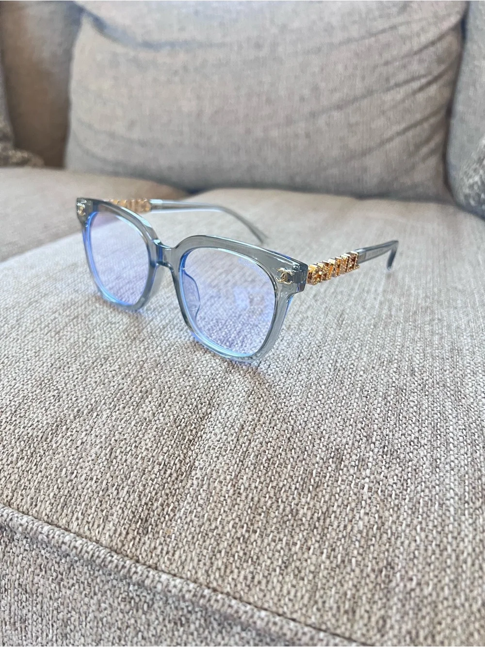 CHANEL Transparent Light Blue Frame Glasses with Gold Logos